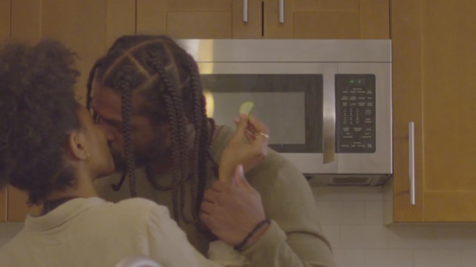 Romantic kiss, catered meal date no-show scene from Let Live Film. Actors Enoch Jones and Cashaey Serenity, pictured. Kiss, black, african-american, couples, braids, natural hair, independent film, kitchen.